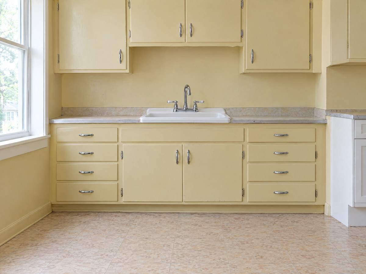 Illustration: the kitchen sink wall before demolition, with the original kitchen still in place