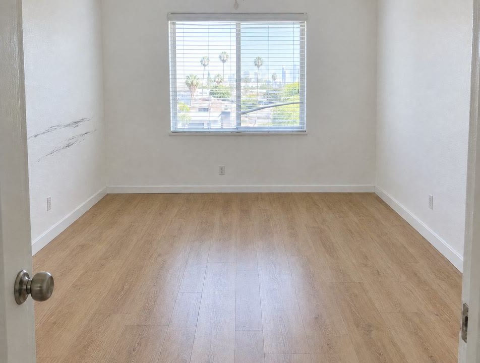 Illustration: an empty rental bedroom at move-out, with scuffs on the wall by the door