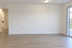 Illustration: scuff on the east wall of an empty living room, just above the left outlet